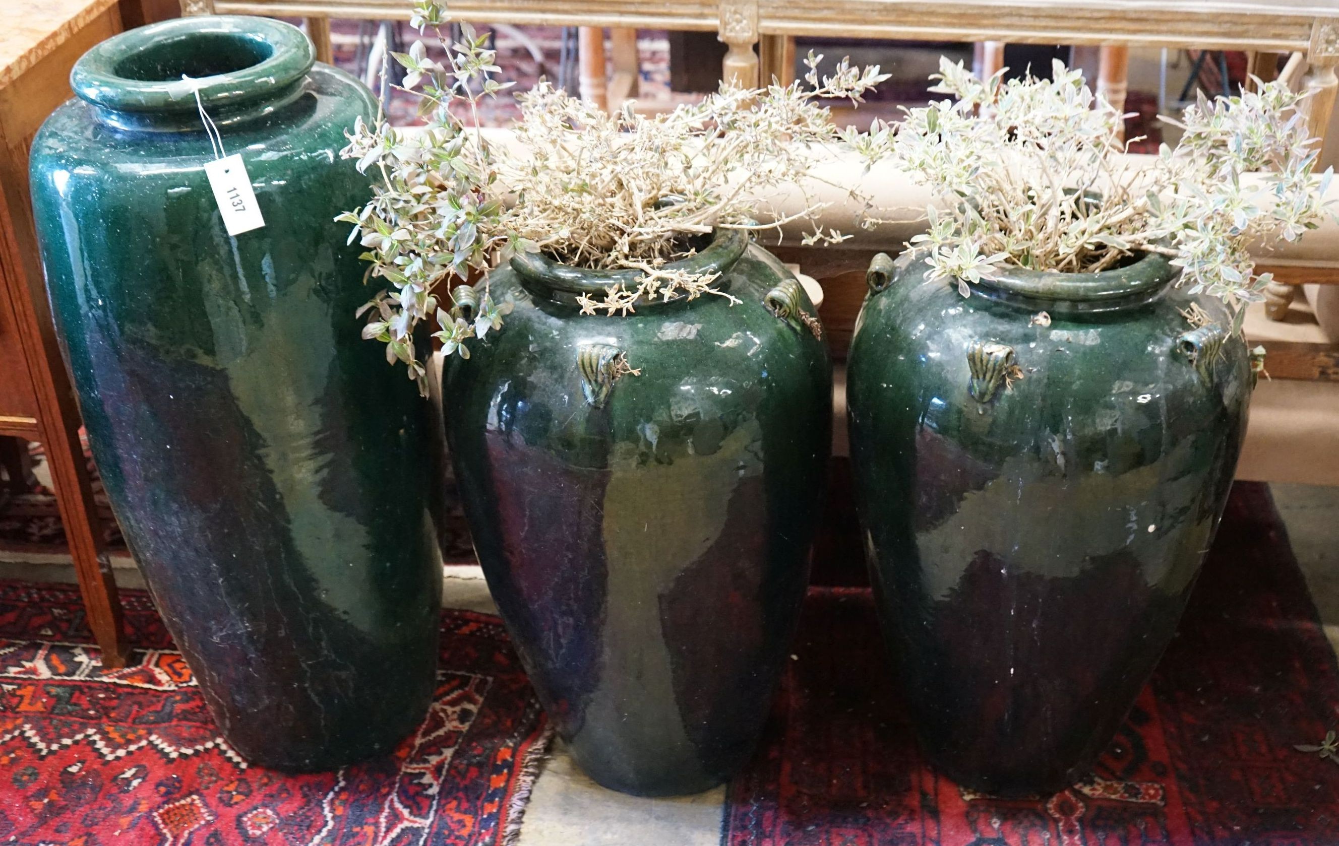 Three (two plus one) green glazed earthenware garden planters, tallest 87cm